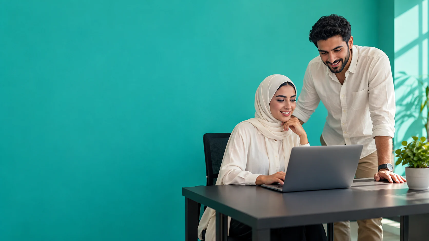 Two founders collaborating on their platform in a teal studio
